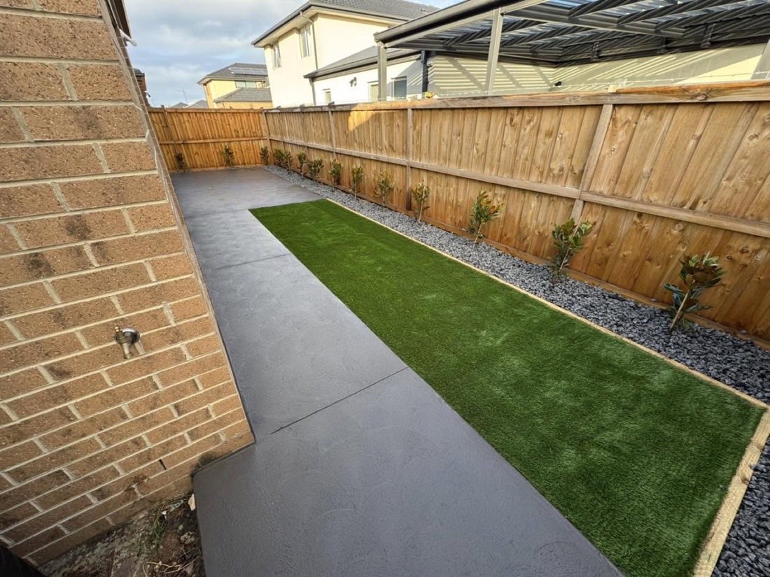Backyard with charcoal concrete path, artificial turf and new garden beds, Melbourne